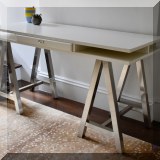 F40. White contemporary desk with chrome legs. 31”h x 58”w x 24”d 